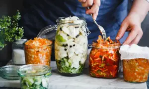 Här är flera burkar med fermenterad mat, inklusive surkål och kimchi, redo att avnjutas.
