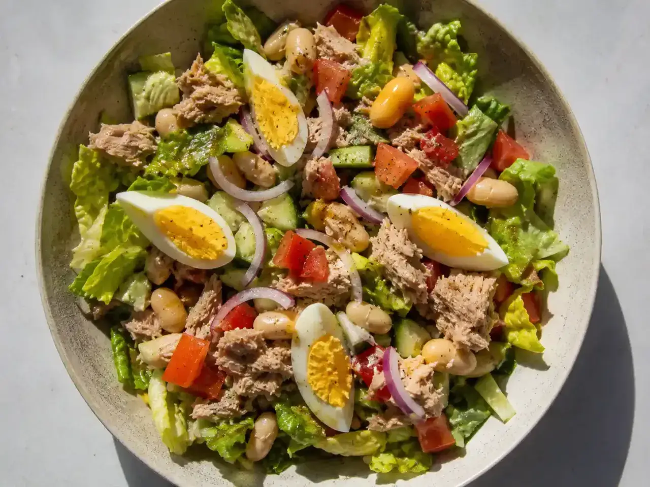 En härlig tonfisk sallad med ägg, bönor, tomat, gurka och rödlök. Perfekt för en lätt lunch.