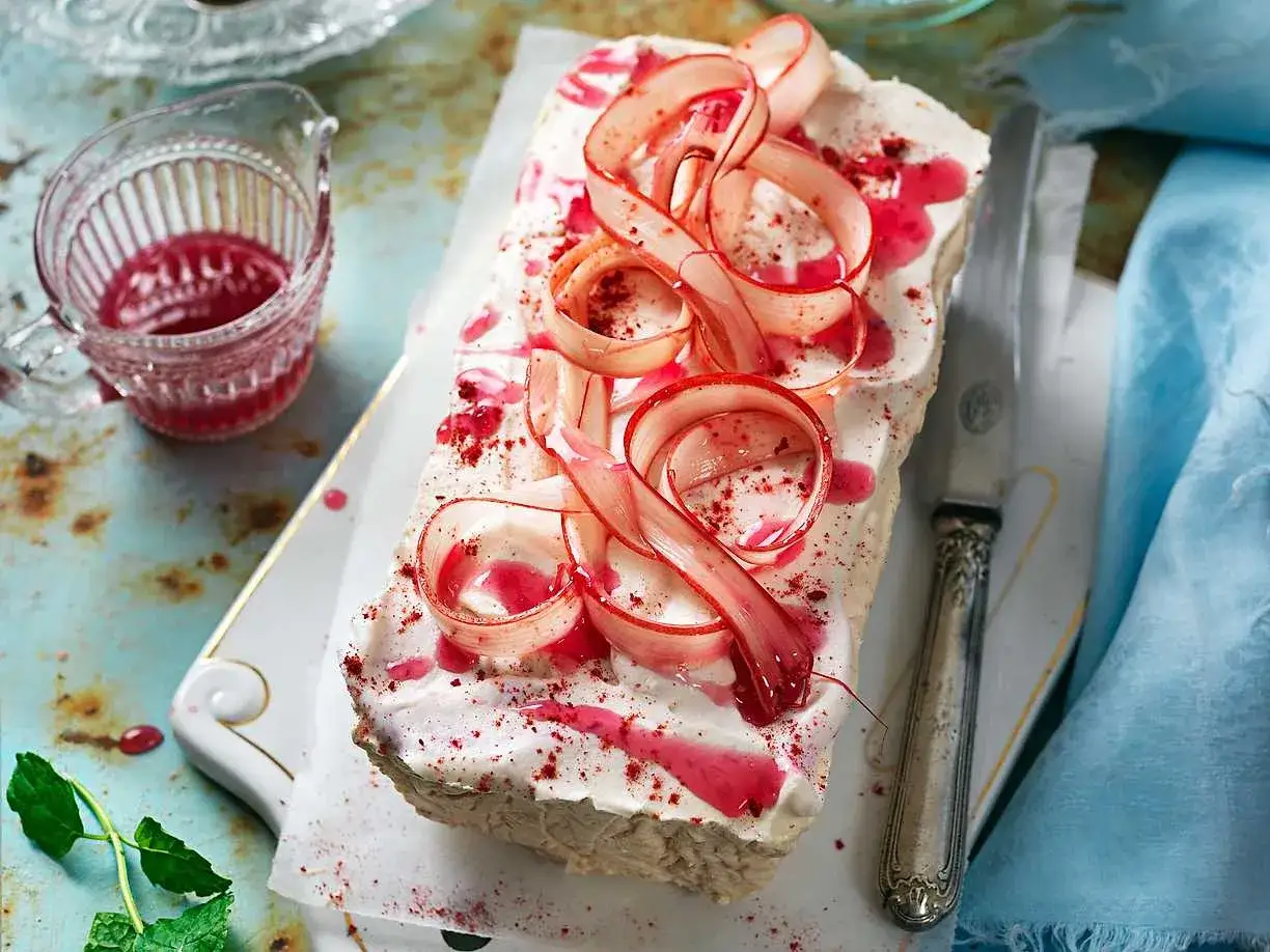 En krämig rabarber cheesecake med virvlar av rabarber och röd sås. En härlig dessert för sommaren.